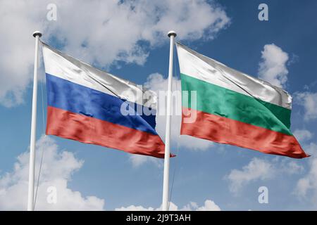 Russia and Bulgaria two flags on flagpoles and blue cloudy sky background Stock Photo