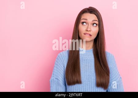 Photo of unsure young brown hairdo lady look promo wear blue sweater isolated on pink color background Stock Photo