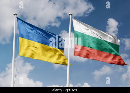 Ukraine and Bulgaria two flags on flagpoles and blue cloudy sky background Stock Photo