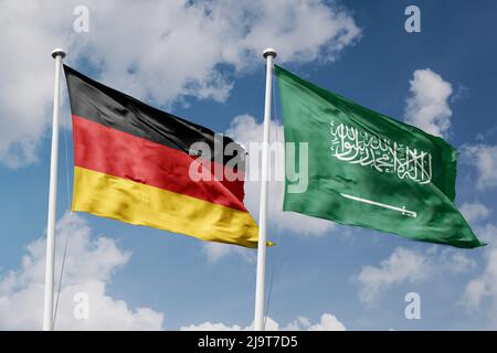Germany and Saudi Arabia two flags on flagpoles and blue cloudy sky background Stock Photo