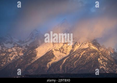 USA, Wyoming, Grand Teton National Park. Storm clouds over Grand Teton Range at sunset. Stock Photo