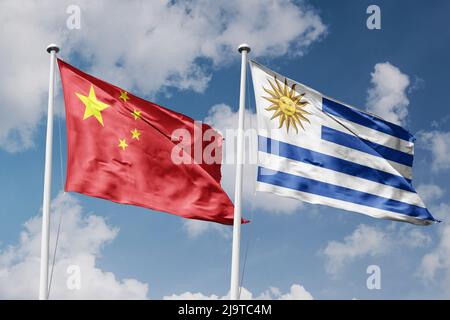 China and Uruguay two flags on flagpoles and blue cloudy sky background Stock Photo