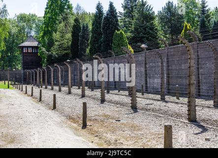 Barbed wire and watchtower around the Auschwitz-Birkenau concentration camp. Oswiecim, Poland, 16 May 2022 Stock Photo