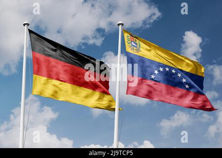 Germany and Venezuela two flags on flagpoles and blue cloudy sky background Stock Photo
