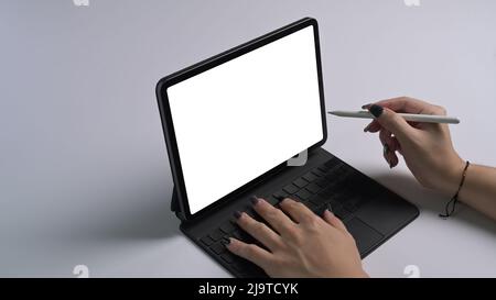 Cropped shot woman holding stylus pen pointing on digital tablet screen. Stock Photo