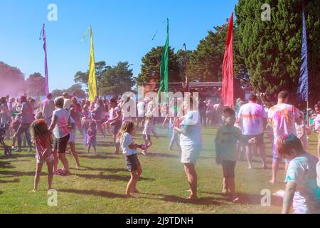 People celebrating Holi, the Hindu festival of color, by throwing packets of colored powder at each other. Tauranga, New Zealand Stock Photo