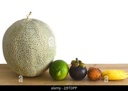Many vietnamese fruit on wooden table against white background Stock Photo