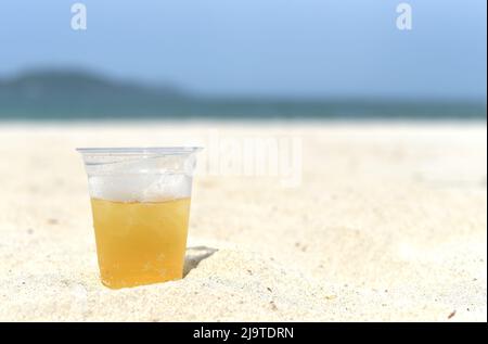 Cold vietnamese beer in cup with ice on white sand beach of Nha Trang Vietnam Stock Photo