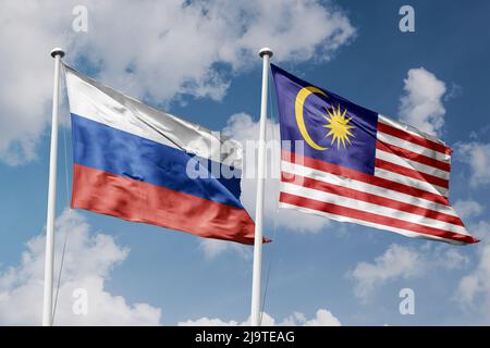 Russia and Malaysia two flags on flagpoles and blue cloudy sky background Stock Photo