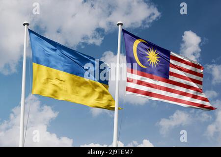 Ukraine and Malaysia two flags on flagpoles and blue cloudy sky background Stock Photo