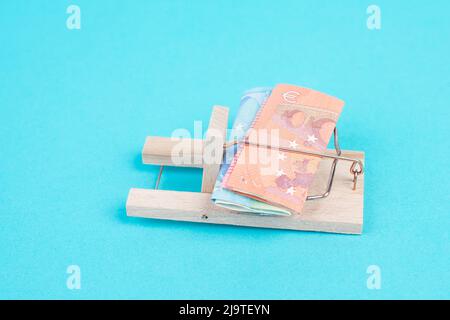 Euro banknotes in a mousetrap, bank loan, finanicial debt, inflation, risky credit and investment Stock Photo