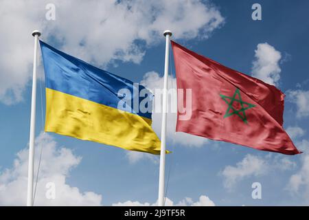 Ukraine and Morocco two flags on flagpoles and blue cloudy sky background Stock Photo