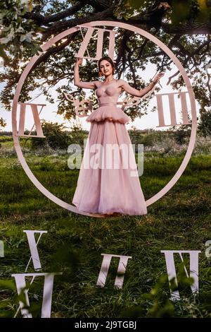 Beautiful woman with big wooden clocks Stock Photo - Alamy