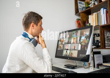 Young man having Zoom video conference call via computer. Stock Photo
