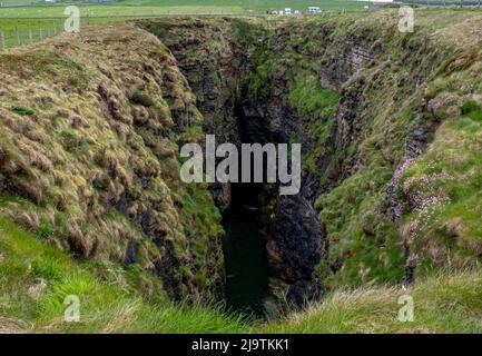 The Gloup, collapsed sea cave, Mull Head, Deerness, Orkney, Scotland. Stock Photo