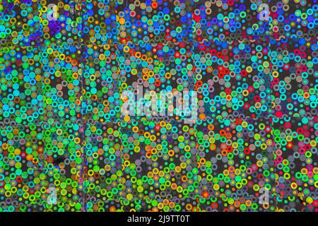 Luminescent and iridescent wrapping paper texture with multi colored concentric circles and black background perfect for backgrounds and graphic desig Stock Photo