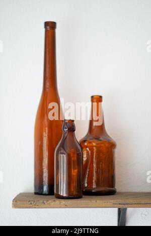 Empty old vintage wine glass bottles on the wooden shelf Stock Photo