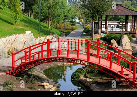 Red Japanese bridge above water Stock Photo - Alamy