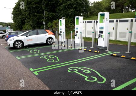 New Gridserve bank of EV charging points Junction 30 on M5 features 12 high-power chargers with a maximum 350kW capacity – enough for the latest elect Stock Photo