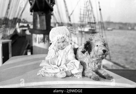 Sam Hood - Baby and a Dog on a Sailing Ship - 1910 Stock Photo