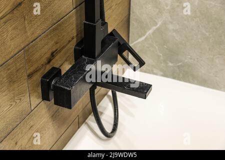 Black faucet with limescale deposits due to water hardness close-up Stock Photo