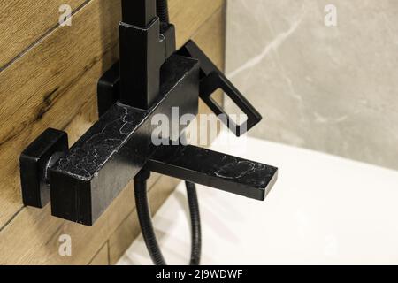 Black faucet with limescale deposits due to water hardness close-up Stock Photo