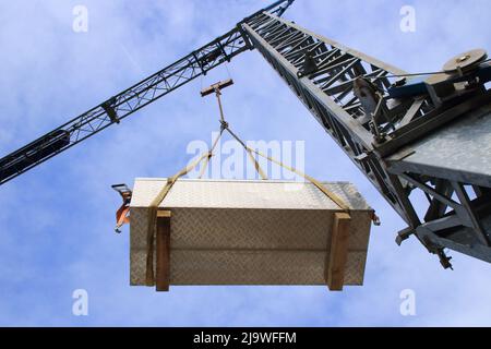 flying load under a construction crane Stock Photo - Alamy