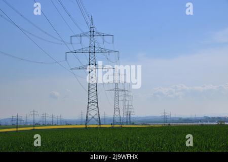 Several high voltage pylons against a blue sky Stock Photo
