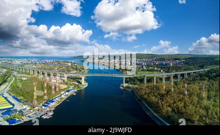 Panorama of bird's eye view of concrete sturdy road bridge between land of modern infrastructure seaside city of Sozopol with multi-storey architectur Stock Photo