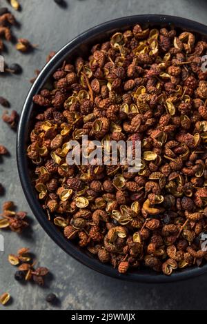 Organic Raw Sichaun Peppercorns in a Bowl Stock Photo