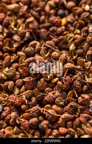 Organic Raw Sichaun Peppercorns in a Bowl Stock Photo