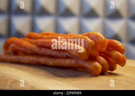 Polish smoked cabanossi sausages on a wooden surface. Stock Photo