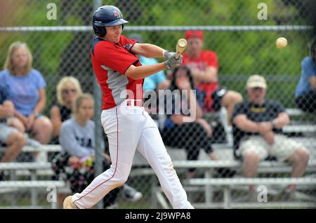 USA. Batter making contact with a pitch that resulted in a fly ball to center field during a high school baseball game. Stock Photo