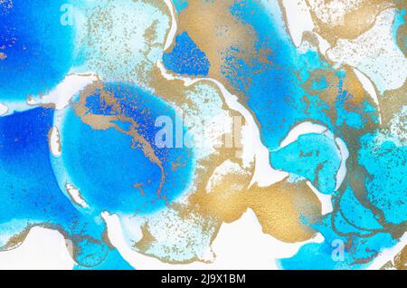 Alcohol-based ink texture in blue tones with gold. Copy space. Stock Photo