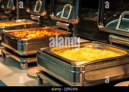 Buffet heated trays ready for service with pasta choice for breakfast Stock Photo