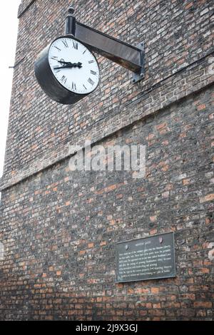 Clock on brick wall traditional uk england Stock Photo