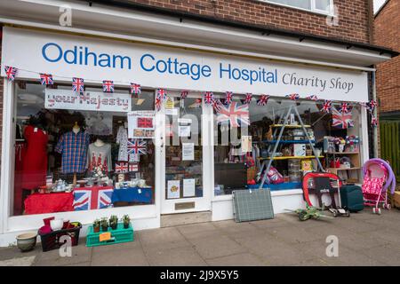 Odiham Cottage Hospital charity shop with a platinum jubilee window display for the Queen's 70 years celebration, May 2022, Old Basing, Hampshire, UK Stock Photo