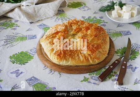 Greek pie spanakopita on table with tablecloth. Ideas and recipes for vegetarian from fillo pastry Stock Photo