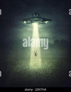 Mysterious alien spaceship abduction scene. Surreal concept with a levitating human stolen by the light of an UFO ship in a dark night on a open field Stock Photo