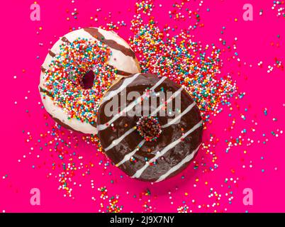Donuts with icing on pink background. Sweet donuts. Donuts background . Eaten donut. Stock Photo