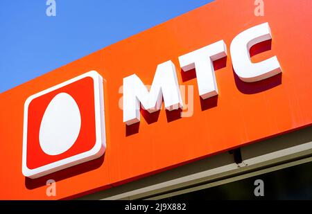 Samara, Russia - May 24, 2022: Logo of the MTS cellular salon against a blue sky Stock Photo