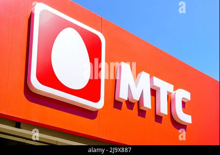 Samara, Russia - May 24, 2022: Logo of the MTS cellular salon against a blue sky Stock Photo