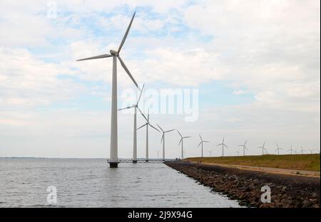 Modern wind turbines in the Noordoostpolder in the Netherlands for sustainable electricity Stock Photo