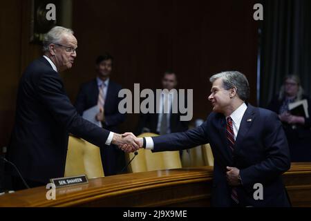 Washington, United States. 25th May, 2022. Senator Jerry Moran, a Republican from Kansas and chair of the Senate Appropriations Subcommittee on Commerce, Justice and Science, shakes hands with Christopher Wray, director of the Federal Bureau of Investigation (FBI), after the conclusion of a Senate Appropriations Subcommittee hearing in Washington, DC on Wednesday, May 25, 2022. Photo by Ting Shen/UPI Credit: UPI/Alamy Live News Stock Photo