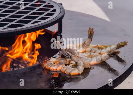 Process of grilling red prawns on brazier with hot flame - close up Stock Photo