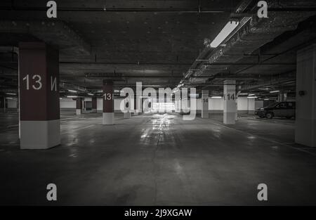 Parking garage, underground interior with a few parked cars Stock Photo