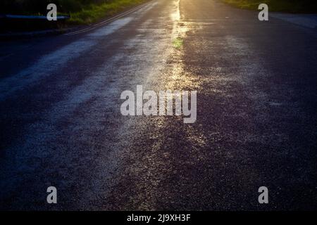 abstract photograph using a long exposure and filter looking into the  strong summer sunlight shining brightly down a road Stock Photo
