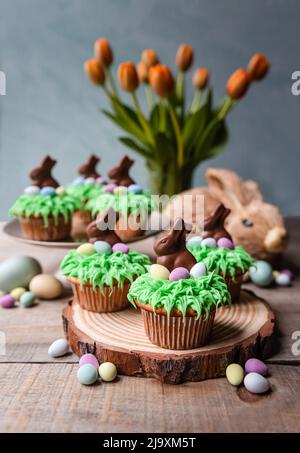 Cupcakes decorated for easter with candy eggs and chocolate bunnies. Stock Photo