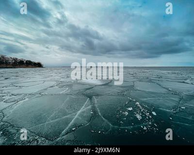 Ice breaking up on Lake Ontario on a cloudy spring day in Canada. Stock Photo