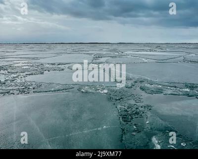 Ice breaking up on Lake Ontario on a cloudy spring day in Canada. Stock Photo